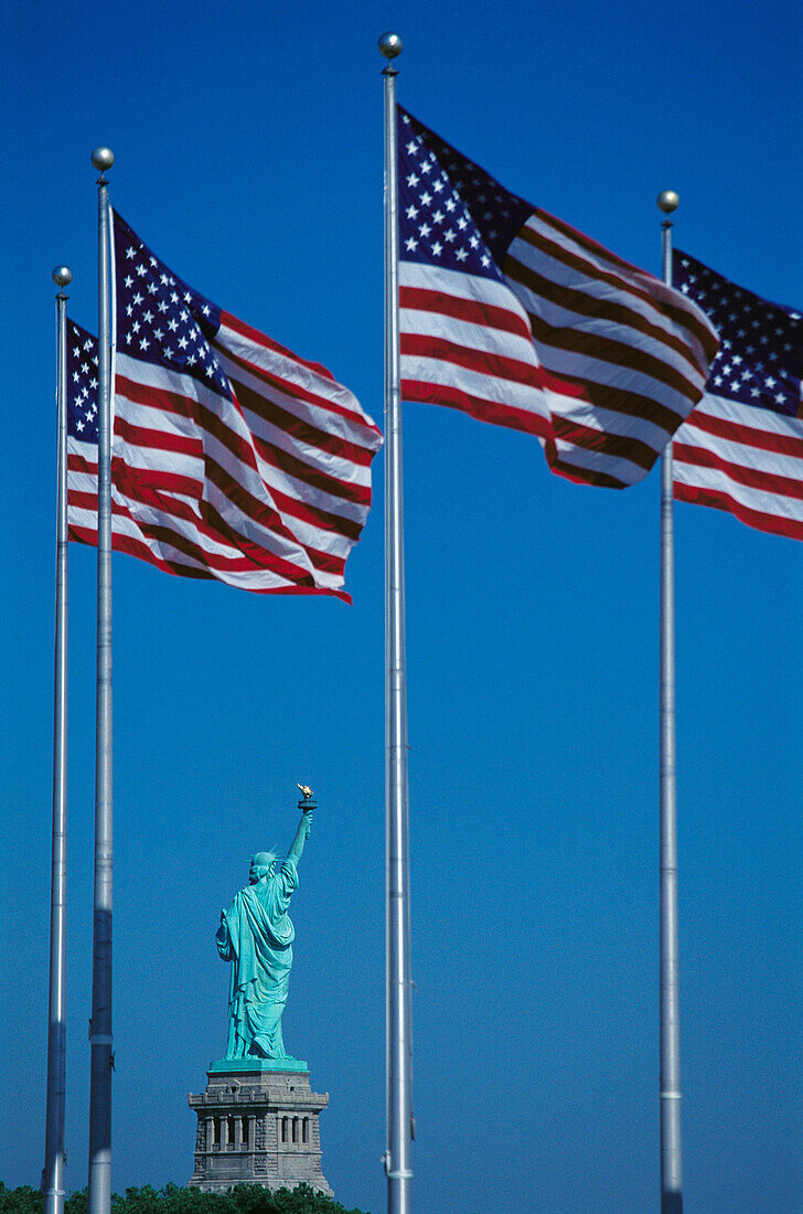 US flags and Statue of Liberty. New Jersey. USA