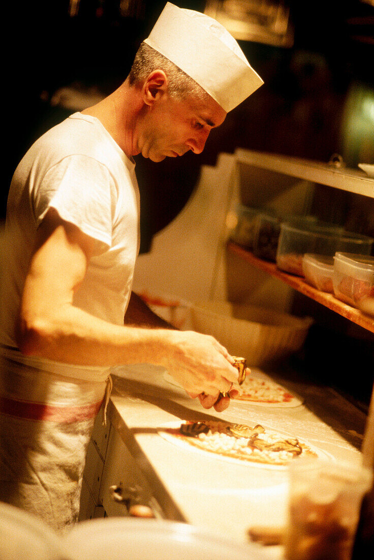 Cook making pizza. Italy