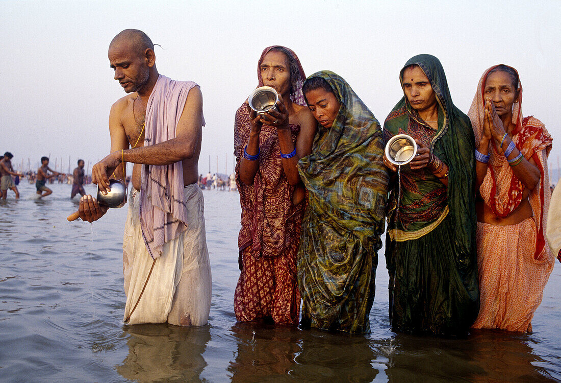 Pilgrims bathing at Sangam (the intersection of Yamuna River and Ganges River) during Kumbh Mela festival, Allahabad. Uttar Pradesh, India