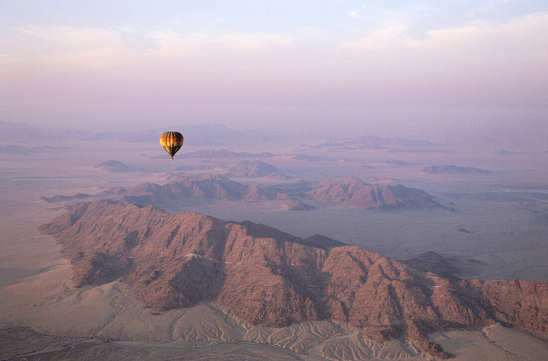 Balloon safari at the edge of the sothern Namib desert. The hot air balloon above the isolated mountain rodges of the pre-Namib. Namibia