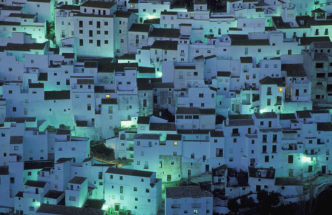 The brilliant White Town of Casares, spectacularly clinging to a steep hillside; at dawn. Province of Málaga, Andalucía, Spain.