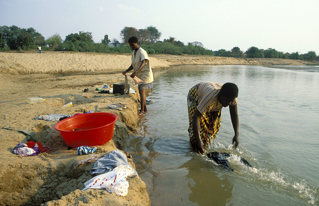 Washing clothes in the Luangwa river just opposite to the South Luangwa National Park. Zambia.