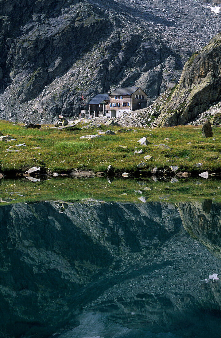 blue-green mountain lake with hut Bächlitalhütte, Grimsel, Berner Oberland, Switzerland