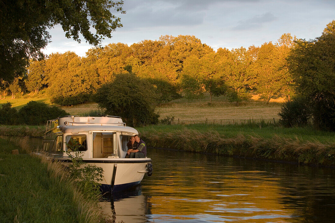 Houseboat Moored on Canal Bank at Sunset, Crown Blue Line Calypso Houseboat, Canal de la Marne au Rhin, near Heming, Alsace, France