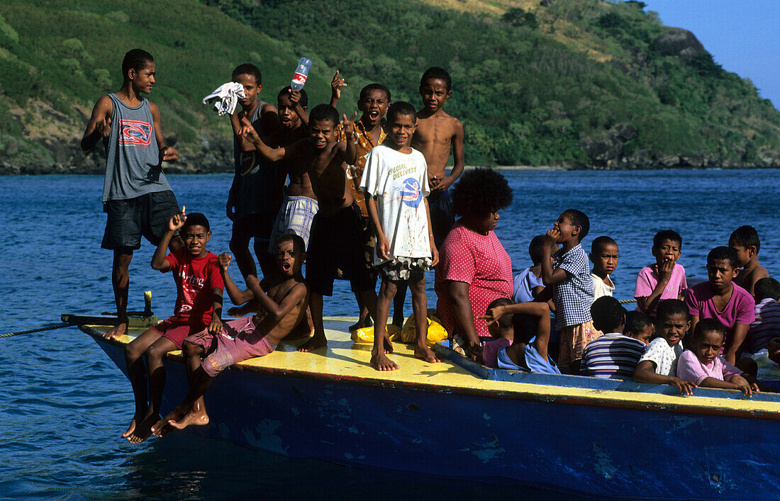 A school boat with children in Octopus Bay off Waya Island, Yasawa group, Fiji, Südsee