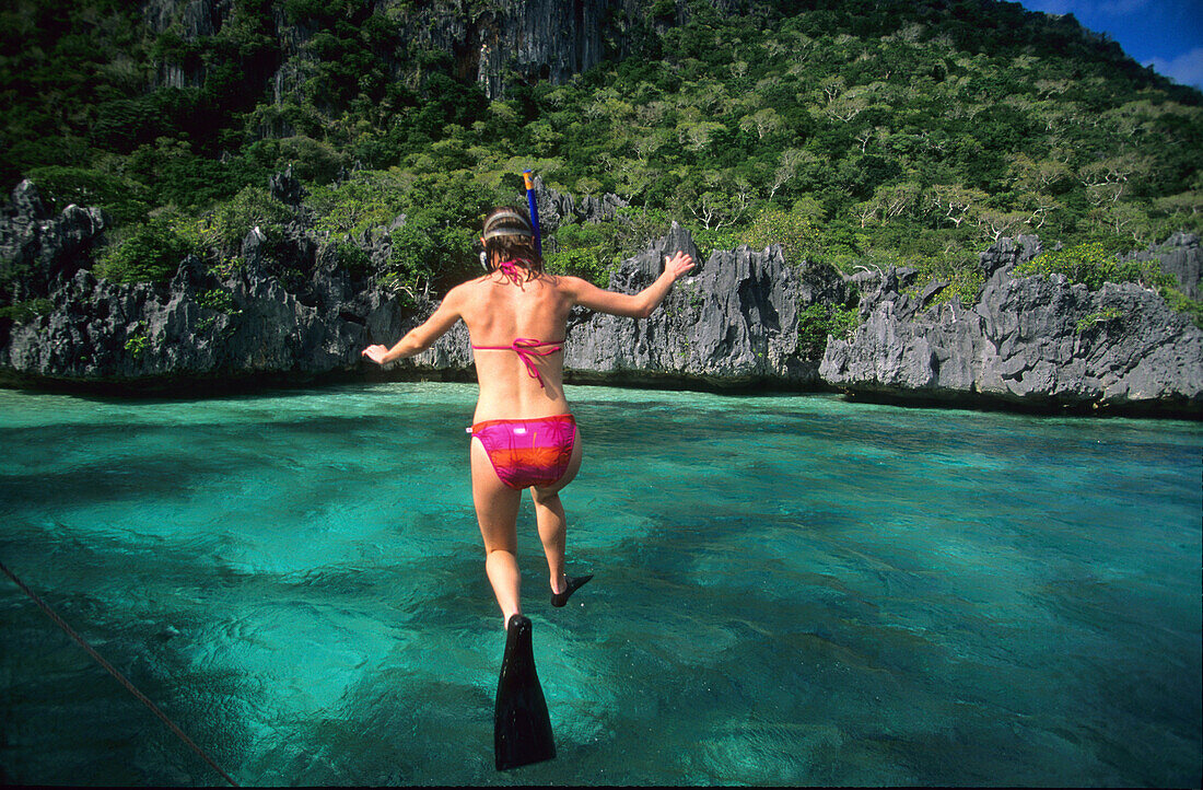 Woman jumping into the water, Snorkeling, Sawa-I-Lau and the Blue Lagoon, Yasawa group, Yasawa group, Fiji, South Sea