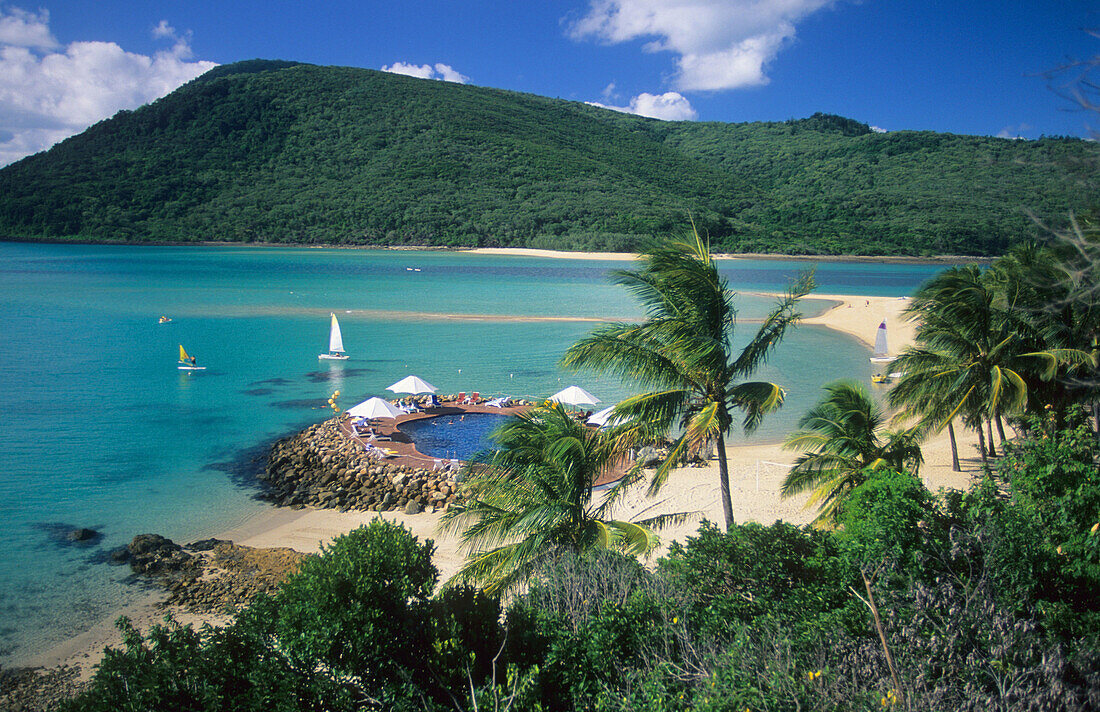 view to resort pool on Brampton Island. Carlisle Island in the background, Whitsunday Islands, Great Barrier Reef, Australia