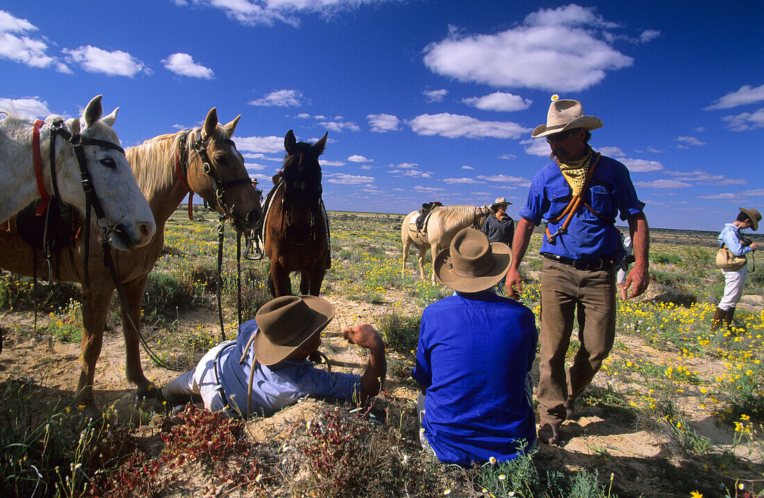 Cowboys having a rest during a cattle drive on Cowarie Station on the Birdsville Track, South Australia, Australia