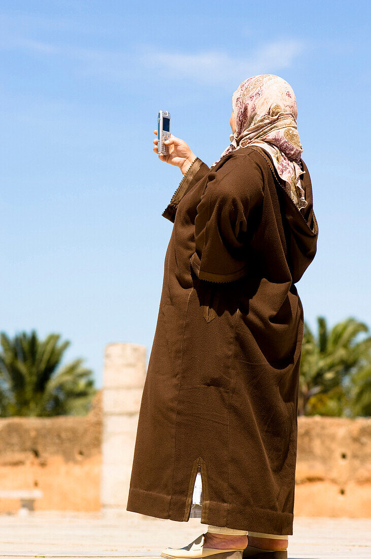 Female arab with mobile camera phone, cell phone camera, Marocco, Africa