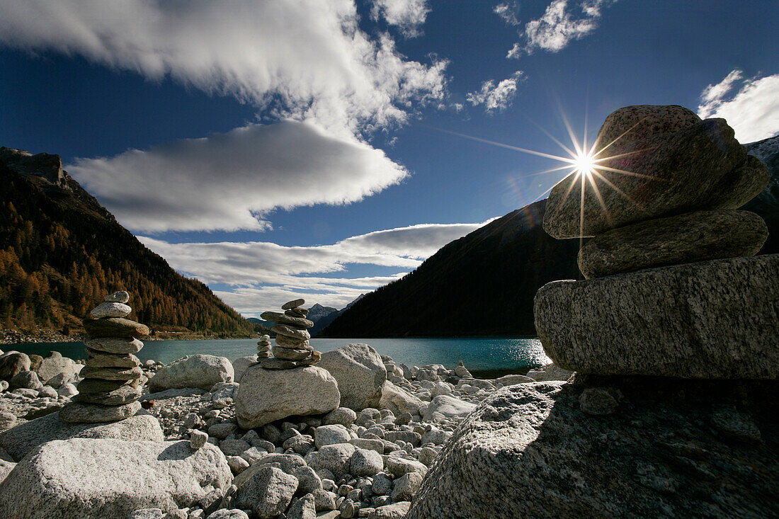 Piles of stones at Neves reservoir in Muhlwald valley, Selva dei Molini near Bruneck, Trentino-Alto Adige/Südtirol, Italy