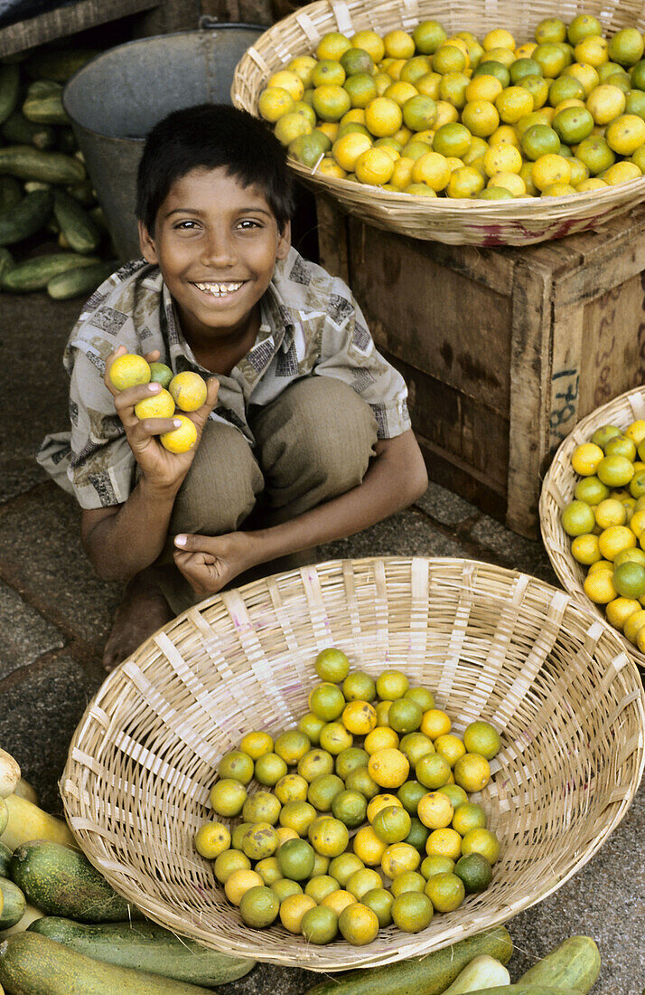 Young boy with limes, India