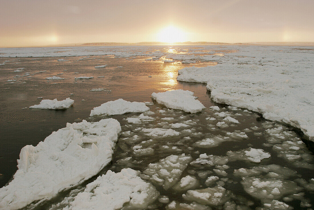 The Churchill River at sunset beginning to freeze-up in early November. Churchill, Manitoba, Canada.