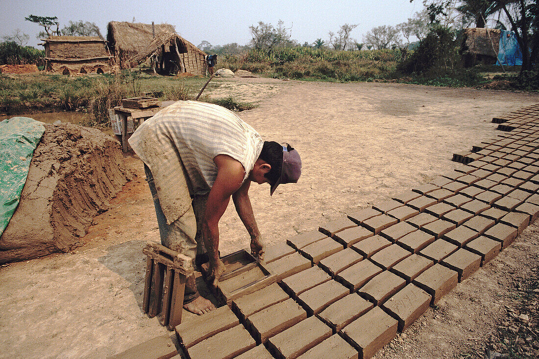 Man making bricks with mud. Moxos. Bolivia