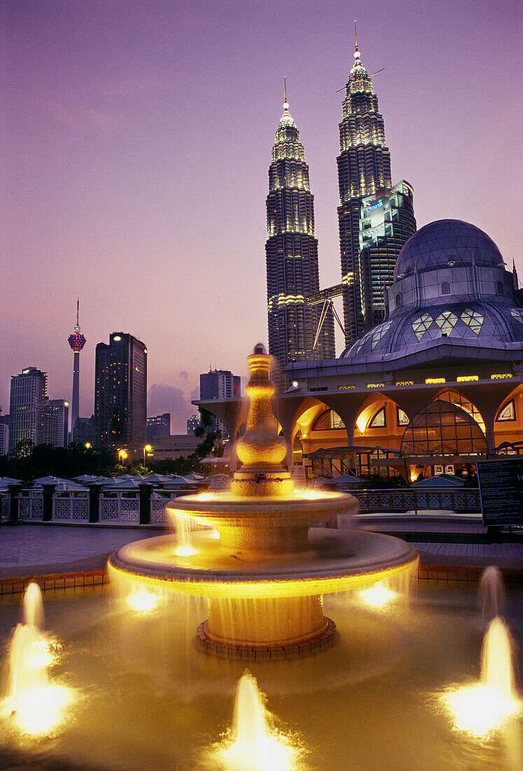 Petronas twin towers (the tallest building in the world), Asy-Syakirin Mosque in the KLCC Park in foreground. Kuala Lumpur. Malaysia
