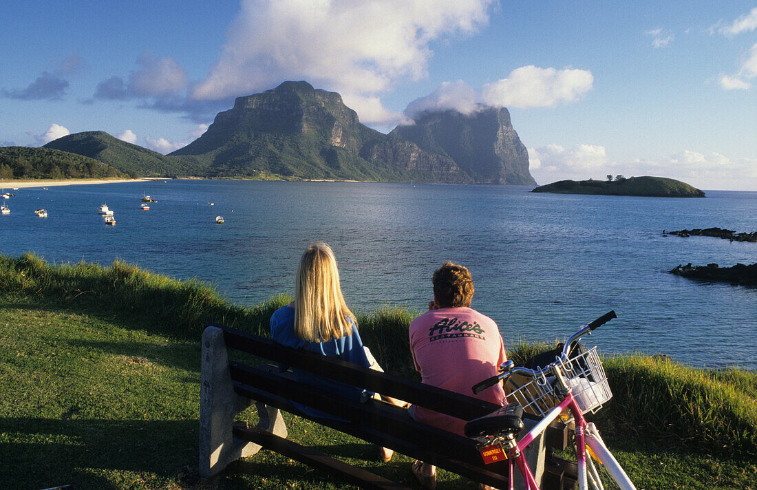 People looking across the lagoon to Mt. Lidgbird and Mt. Gower, Lord Howe Island, Australia