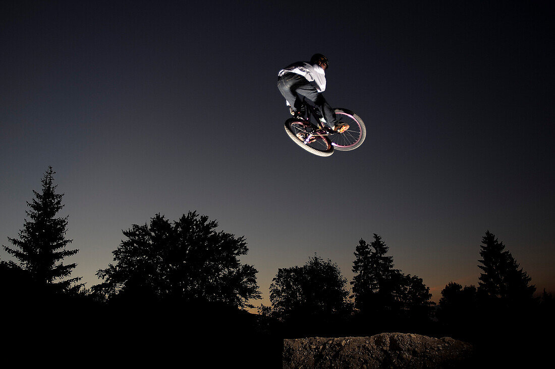 Mountain biker jumping, Oberammergau, Bavaria, Germany