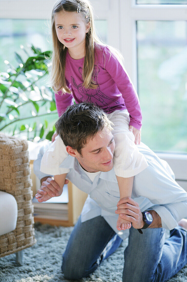 Father giving daughter (3-4 years) piggyback, Munich, Germany