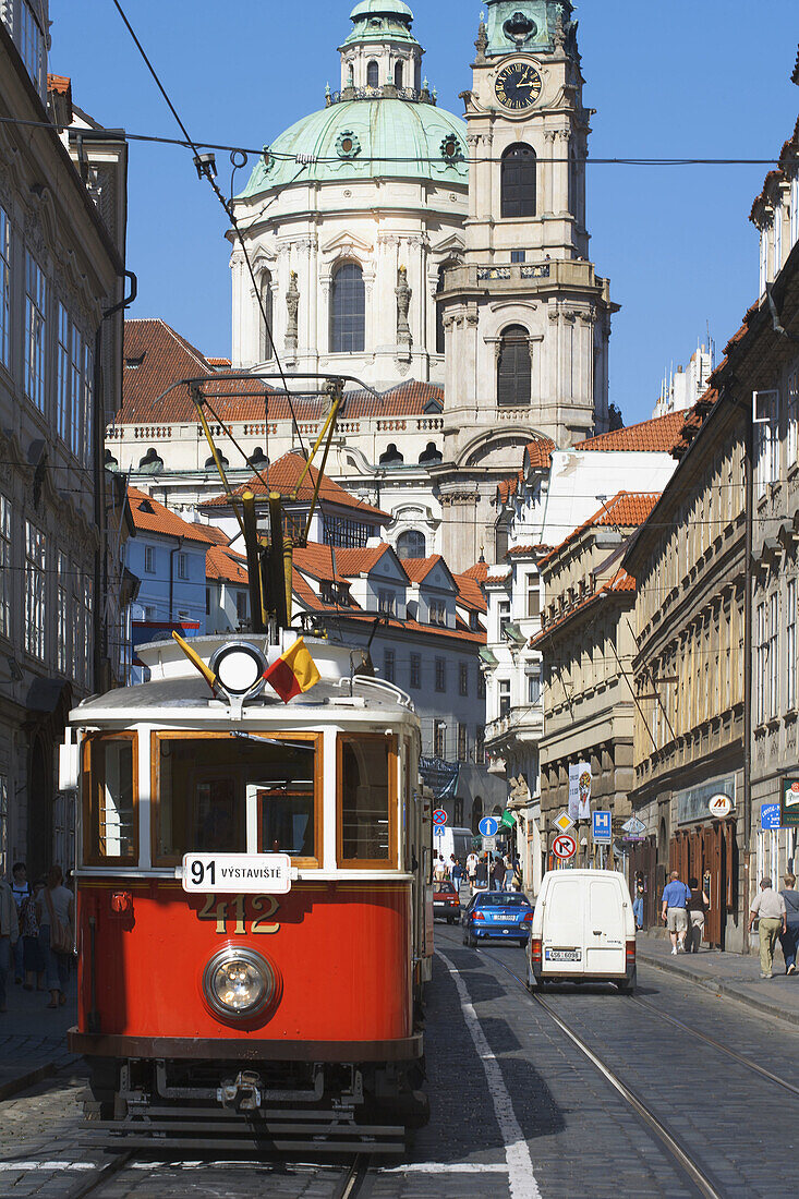 Tram and St. Nicholas Church. Karmelitska street. Prague. Czech Republic