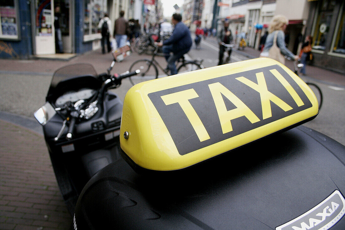 Sign of motorcycle taxi in Haarlemmerdijkstraat, Amsterdam, Holland, Netherlands