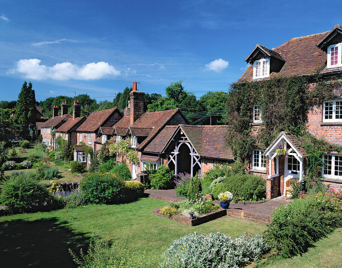 Cottages and wellhouse Ringhall. Late June. Hertfordshire. England. UK.