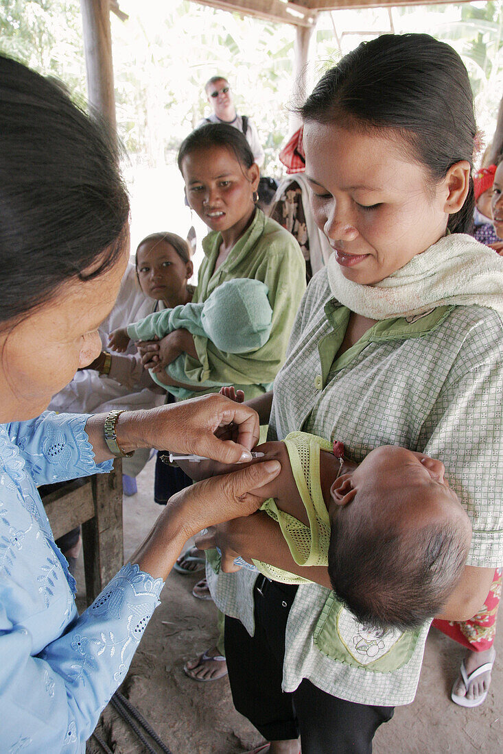 Baby receiving an immunisation shot, at a rural health centre in Kampong Thom. Cambodia