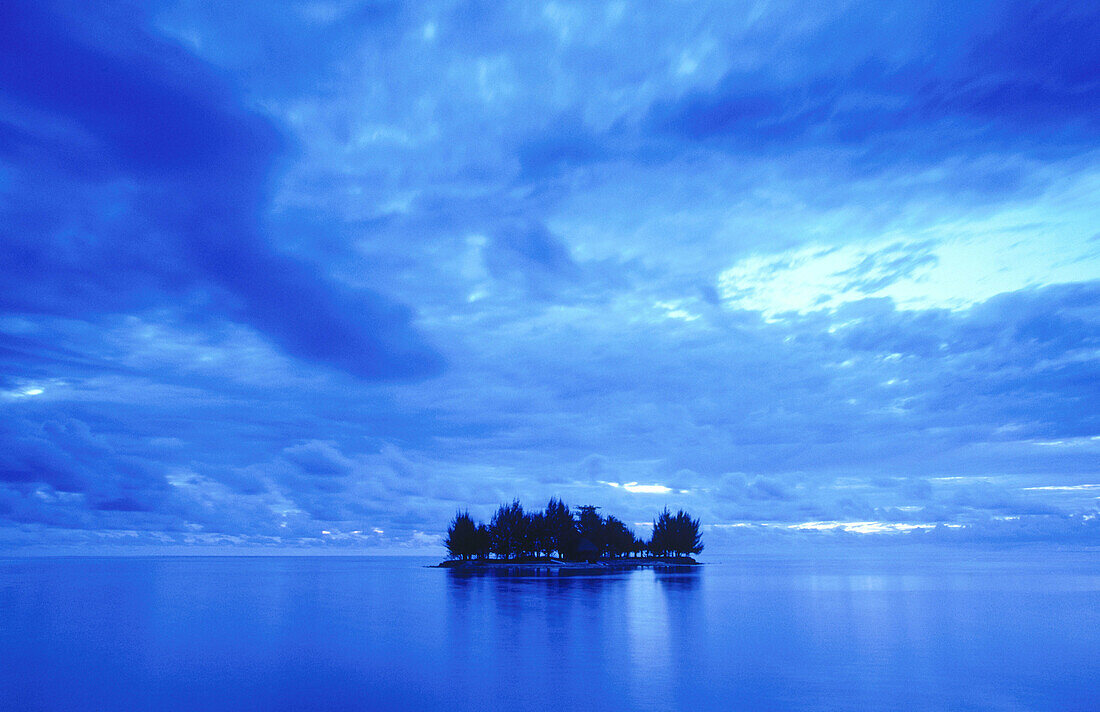 Small motu (island) at dusk. Western Moorea. French Polynesia
