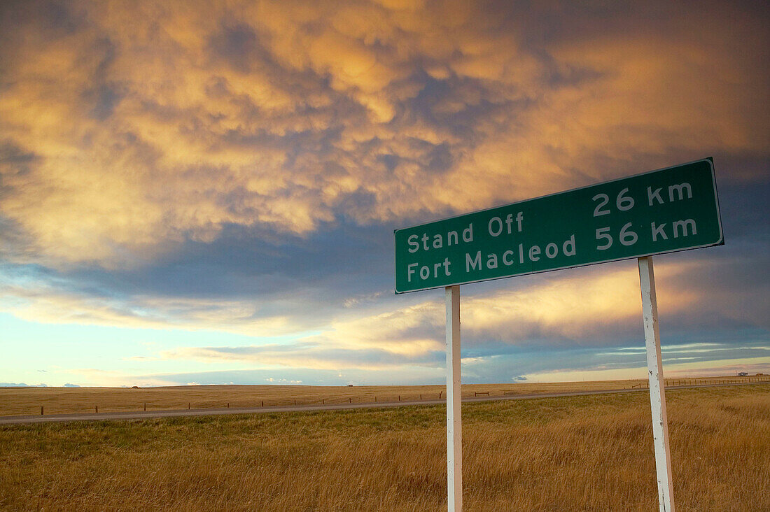 Road sign (Rt. 2), landscape with dramatic sky. Cardston. Alberta, Canada