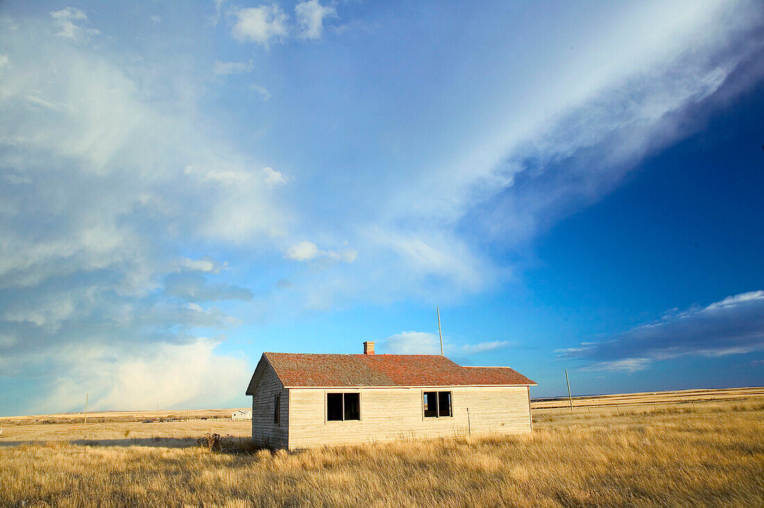 House, landscape with dramatic sky. Cardston. Alberta, Canada