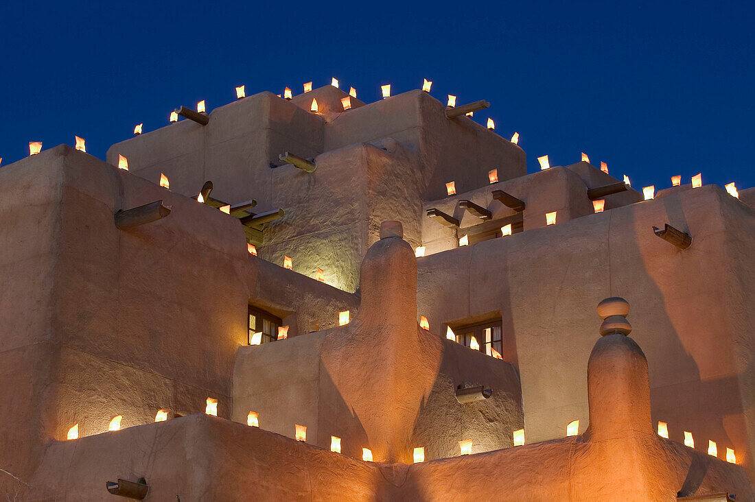 Adobe walls and luminaria candles at Inn and Spa at Loretto in the evening. Santa Fe. New Mexico, USA