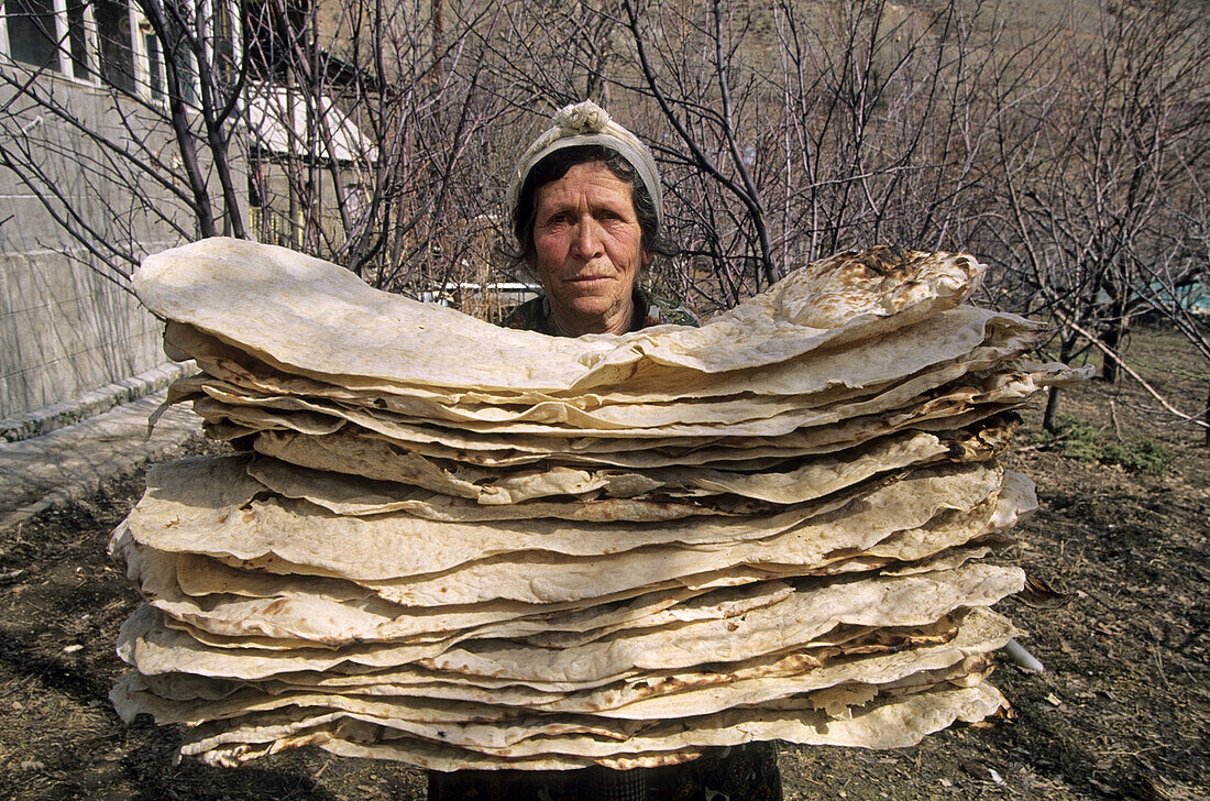 Woman carrying lavash (Armenian cracker bread), Bjni. Armenia