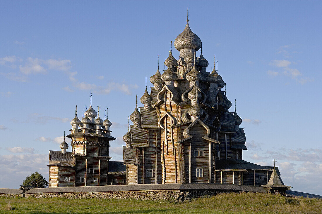 Church of the Intercession of the Mother of God, Pokrovskaia Tserkov, 1764. Church of Transfiguration, Preobrajenskaia Tserkov, 1714. Tower clock, 1874. Kizhi Island. Onega lake, Karelia. Russia.