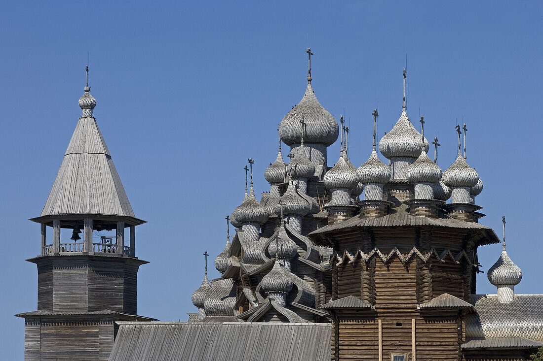 Church of the Intercession of the Mother of God, Pokrovskaia Tserkov, 1764. Church of Transfiguration, Preobrajenskaia Tserkov, 1714. Tower clock, 1874. Kizhi Island. Onega lake, Karelia. Russia.