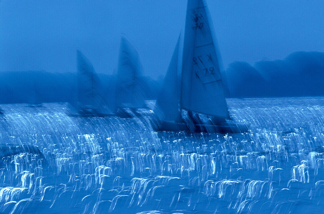  Blue, Blurred, Boat, Boats, Calm, Calmness, Color, Colour, Contemporary, Exterior, Horizontal, Motion, Movement, Moving, Night, Nighttime, Outdoor, Outdoors, Outside, Peaceful, Peacefulness, Quiet, Quietness, Sail, Sailboat, Sailboats, Sailing, Sea, Spor