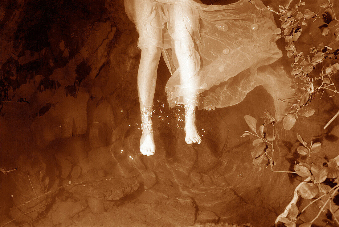 Woman with fabric floating in river