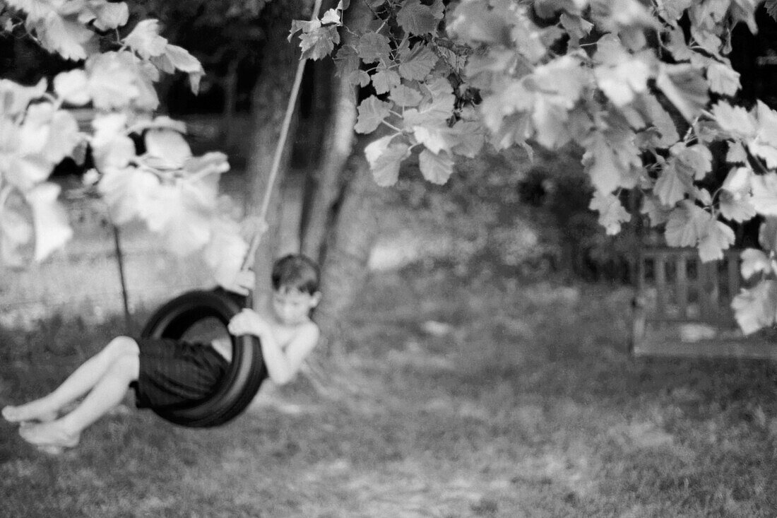 Child, Childhood, Children, Contemporary, Country, Countryside, Daydream, Daytime, Dream, Exterior, Game, Games, Gentle, Hang, Hanging, Horizontal, Human, Infantile, Kid, Kids, Lazy, Leaf, Leaves, Lei