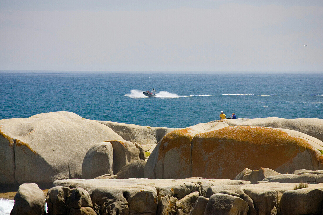 A couple sitting on rocks at Sandy Bay Beach, Cape Town, South Africa, Africa, mr