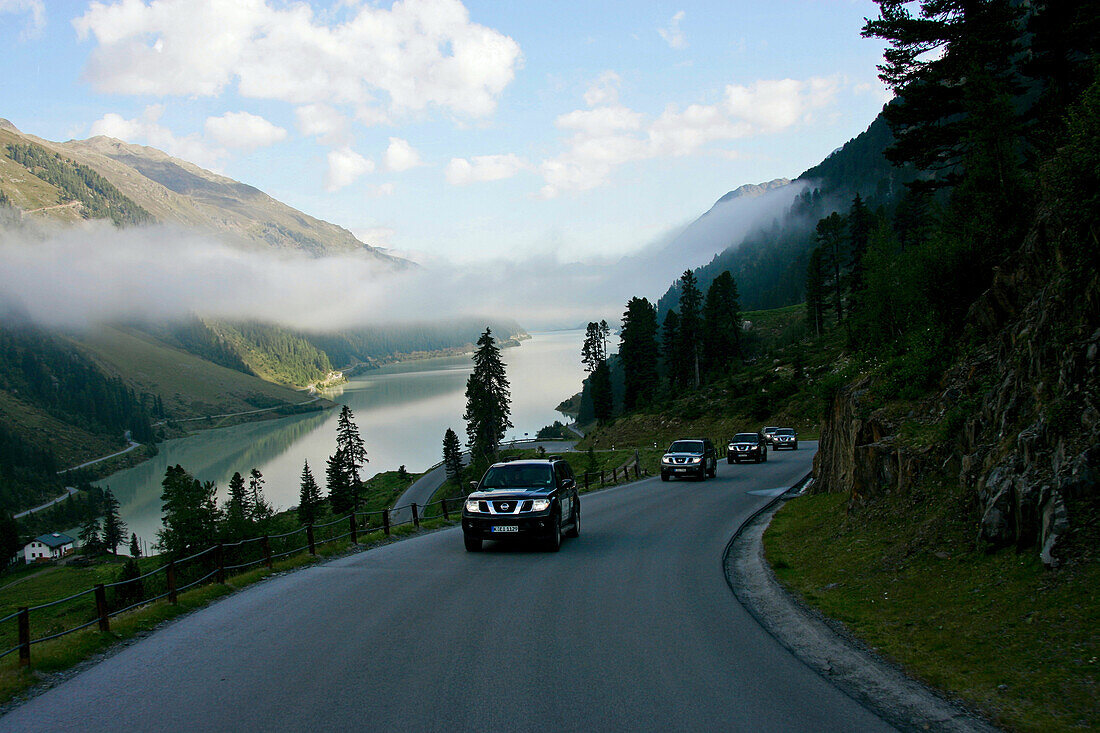 Five 4x4 vehicles on a country road, Kaunertal, Tyrol, Austria, Europe, mr