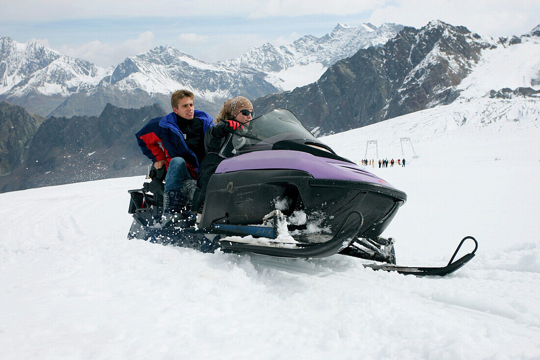 Paar unterwegs mit einem Motorschlitten, Kaunertal Gletscher, Tirol, Österreich
