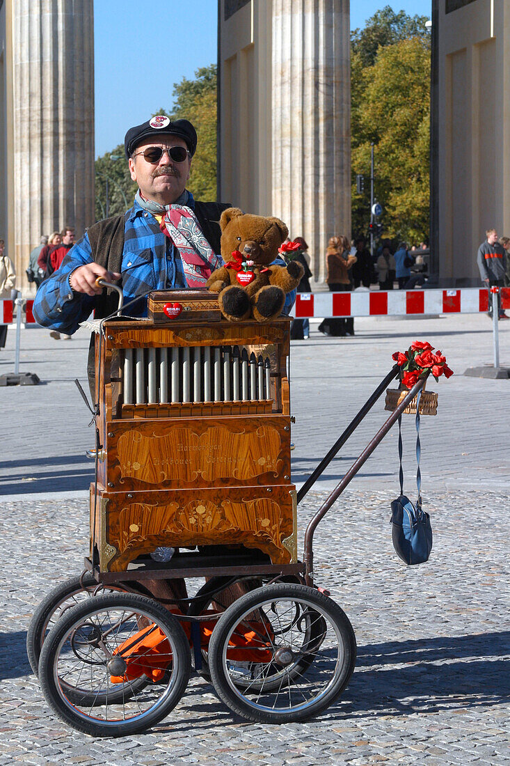 Berlin ,  Brandenburger Tor ,man with barrel organ and berlin bear