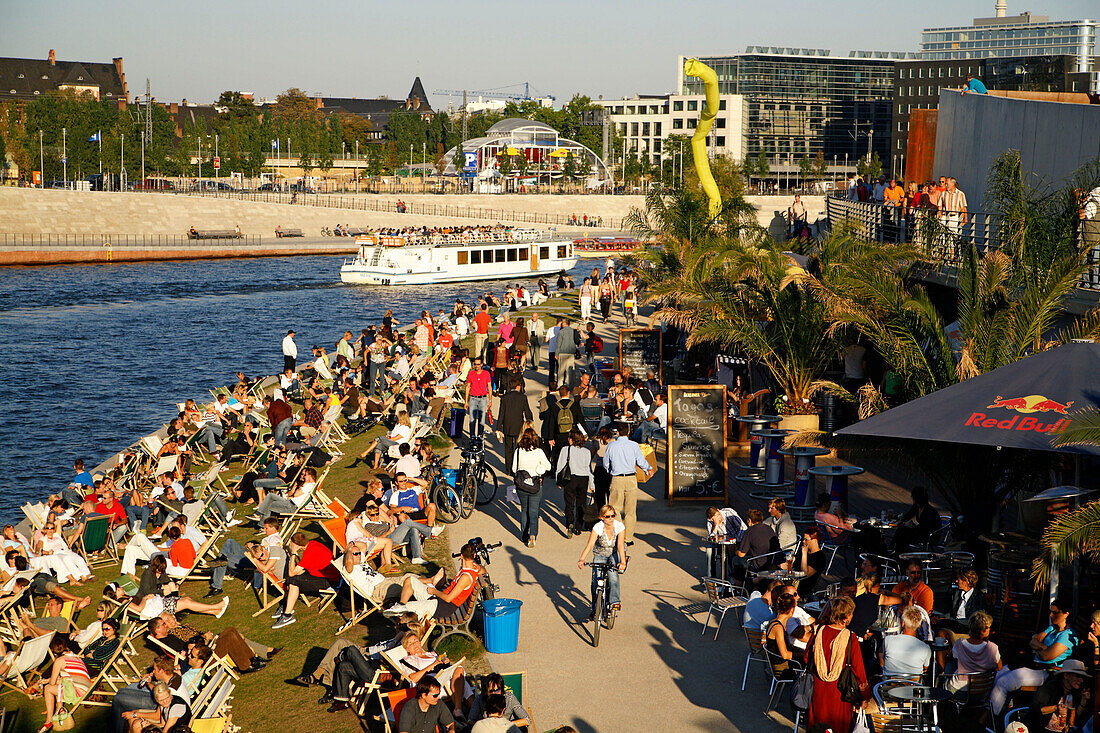 Berlin capital beach near Lehrter main station, riverbank Spree , Tour boat people