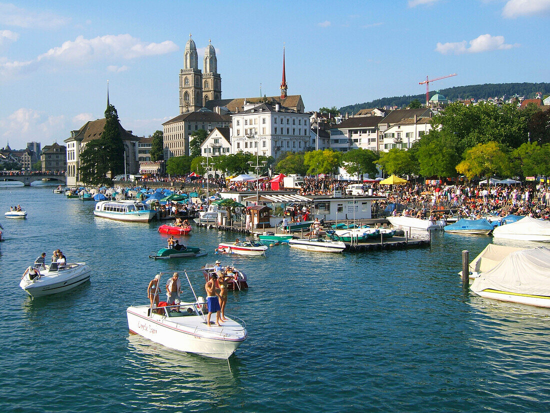 Switzerland, Zurich, street parade,party boats on river Limmat, Grossmuenster, skyline