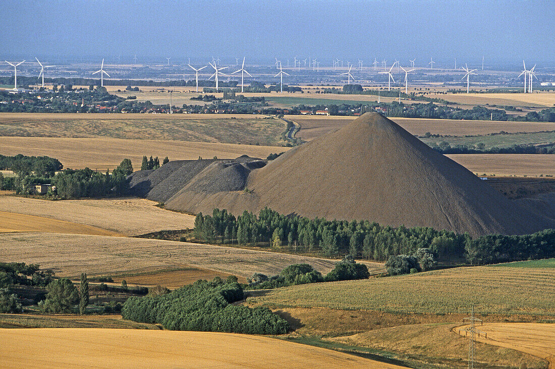 Stockpile and fields, wind farm in background, Mansfelder Land, Mansfeld, Saxony Anhalt, Germany
