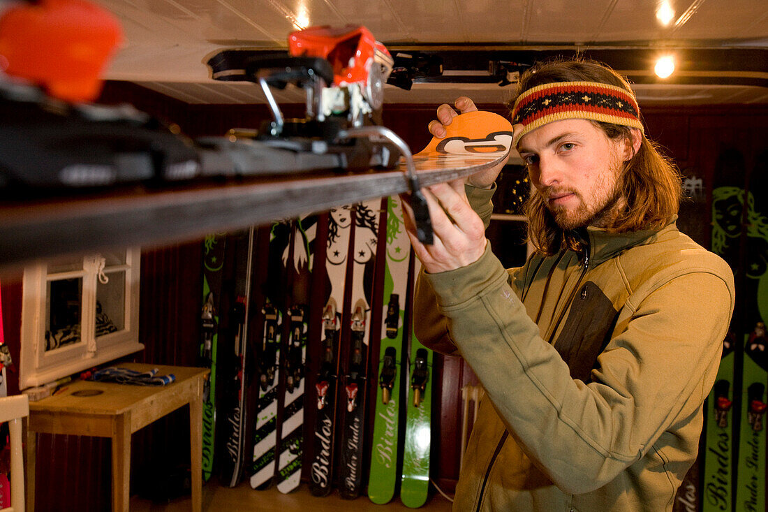 Man checking freeride ski, Andermatt, Canton Uri, Switzerland