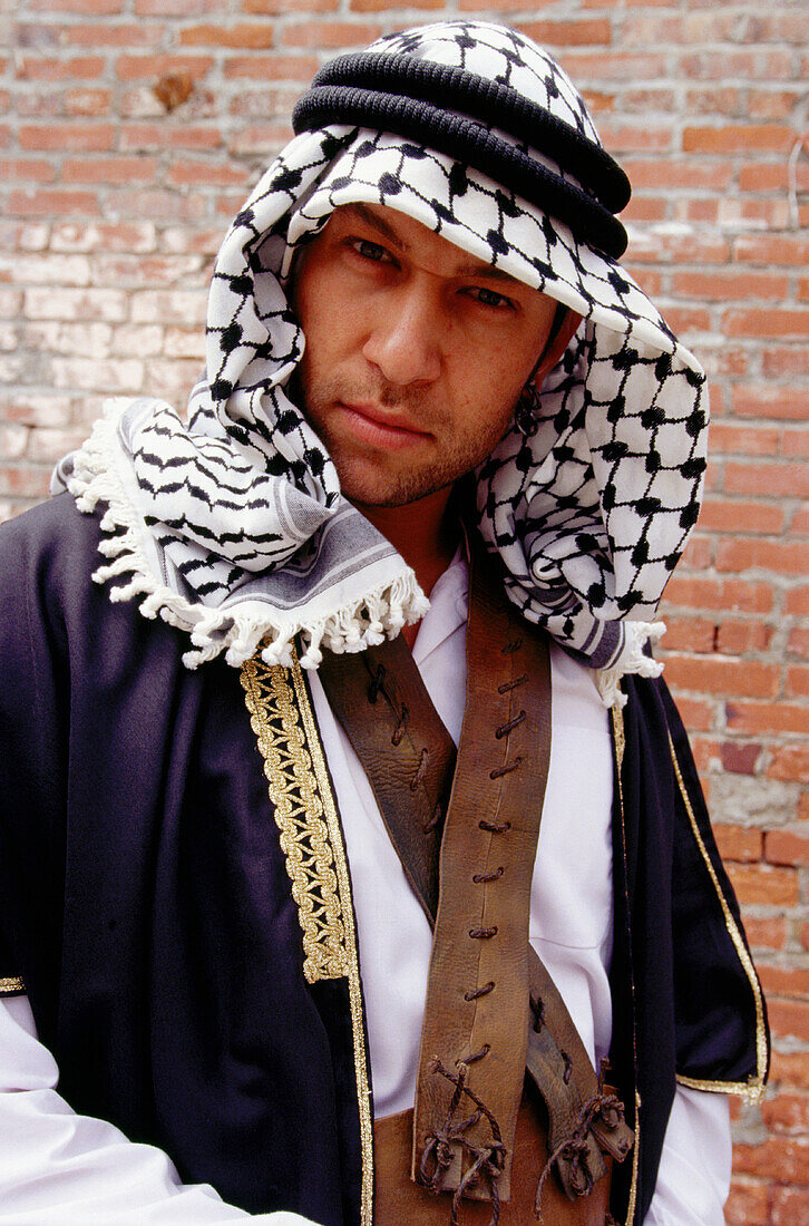 Traditional dressed Palestinian man looking directly down at camera