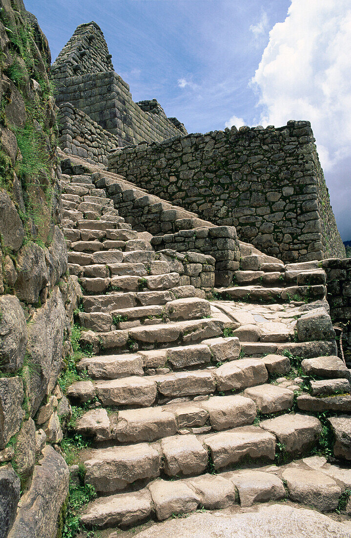Steep stairway at the inca ruins of Machu Picchu. Peru
