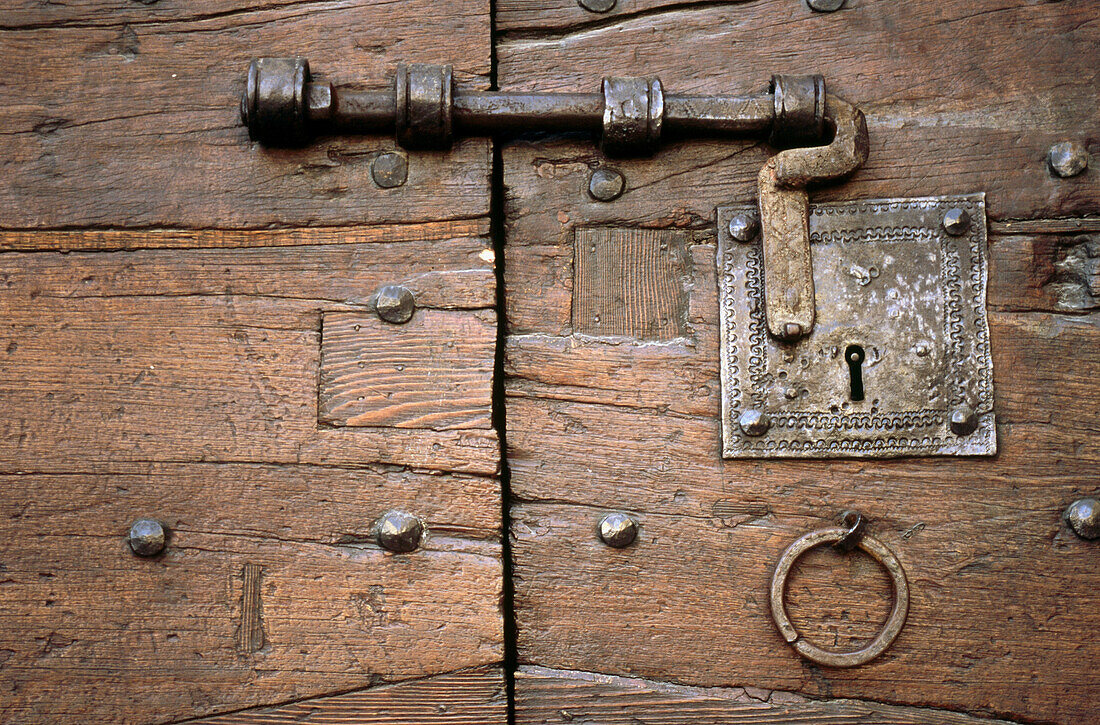 Old lock on a wooden door, Gubbio. Umbria, Italy