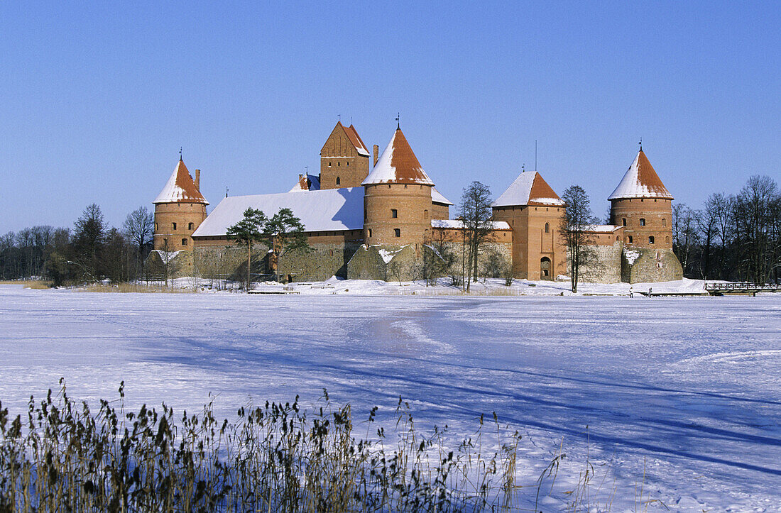 Gothic castle built XIV-XVth century, Lake Galve in winter. Trakai, Lithuania