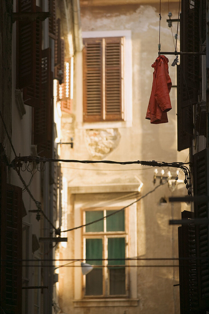 Building Detail with red shirt. Trg 1 Maia (May 1st Square). Piran. Primorska. Slovenia.