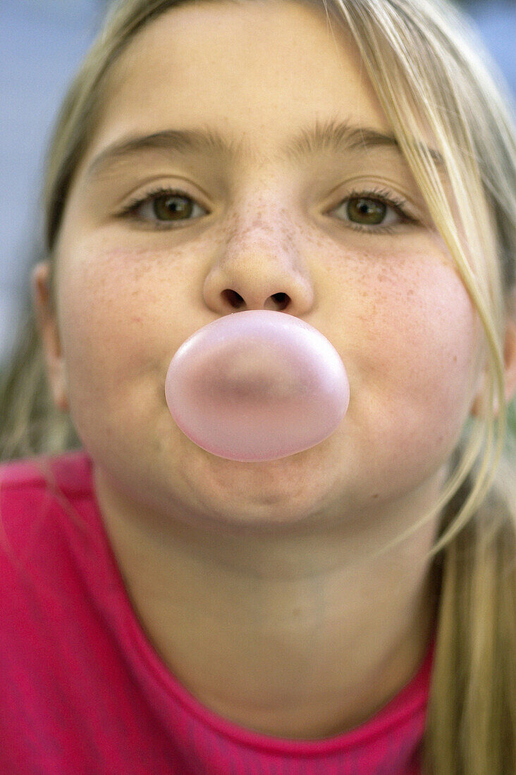 girl blowing gum bubble