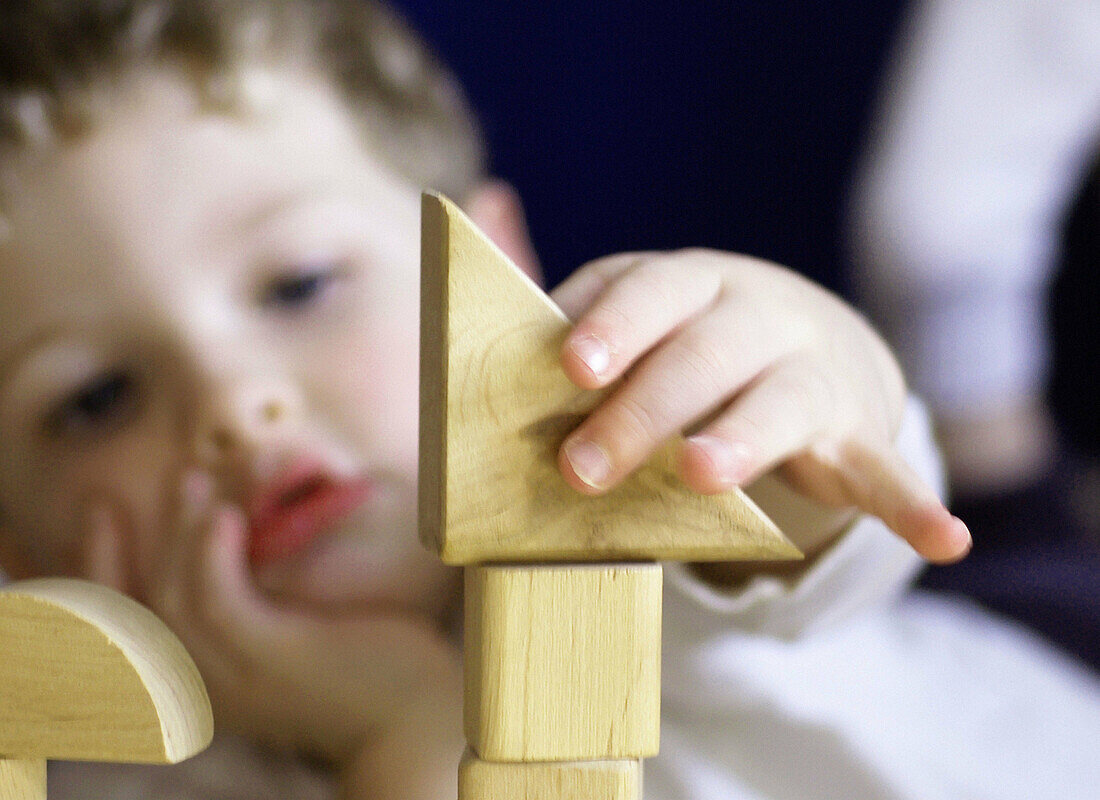 Boy concentrating on building blocks